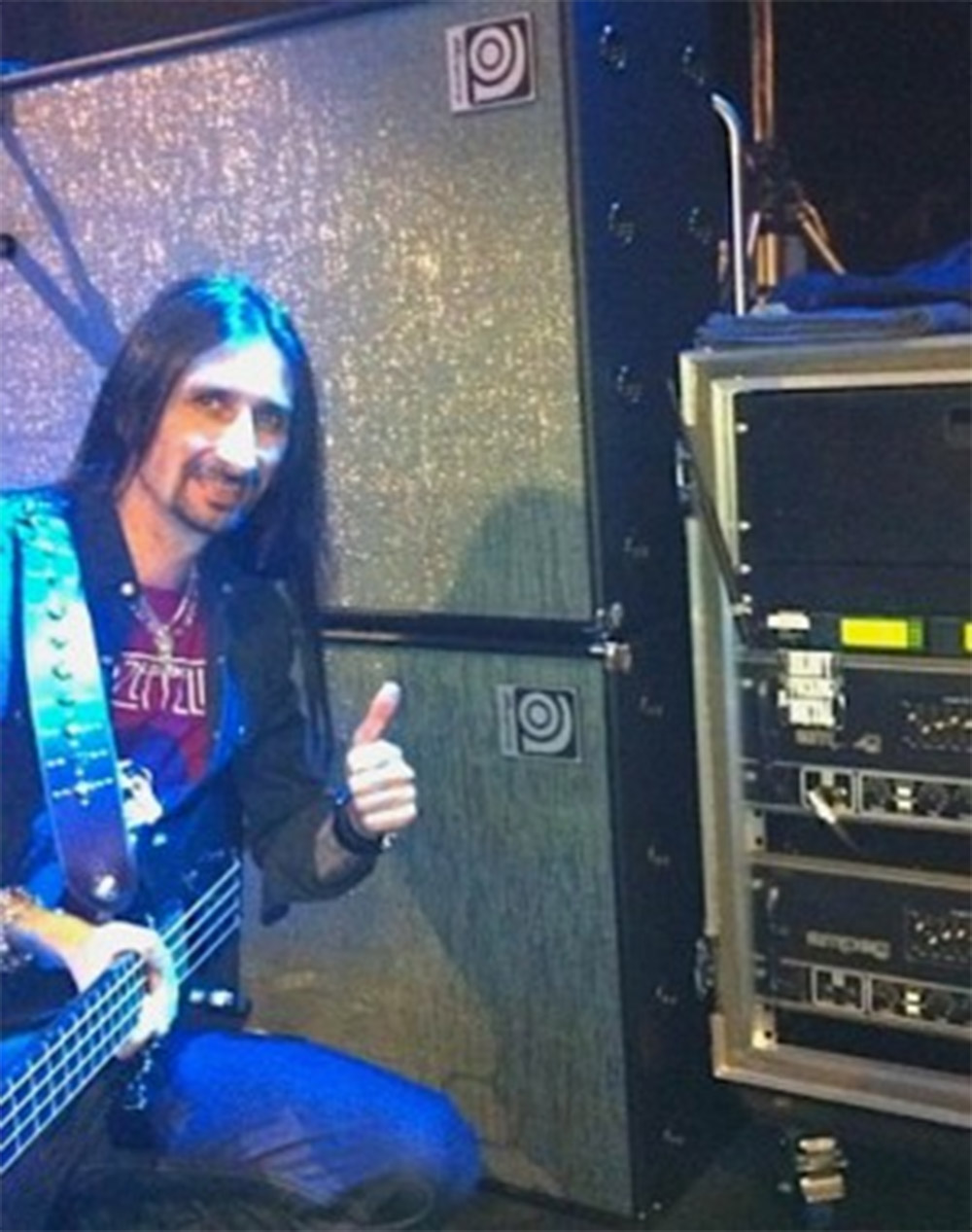 Davey Rimmer in front of SVT cabs holding a bass giving a thumbs up