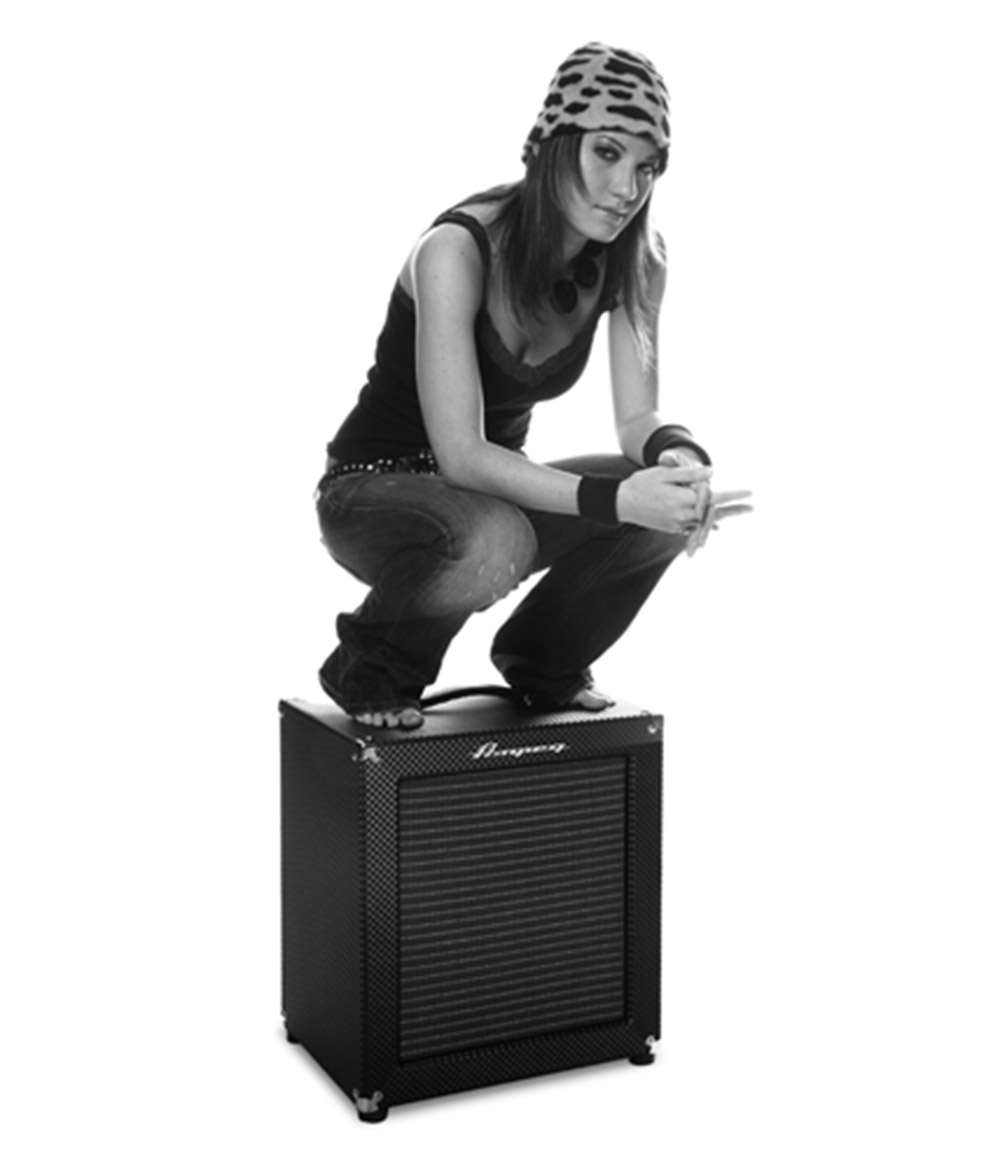 Emma Anzai sitting on a small Ampeg cabinet