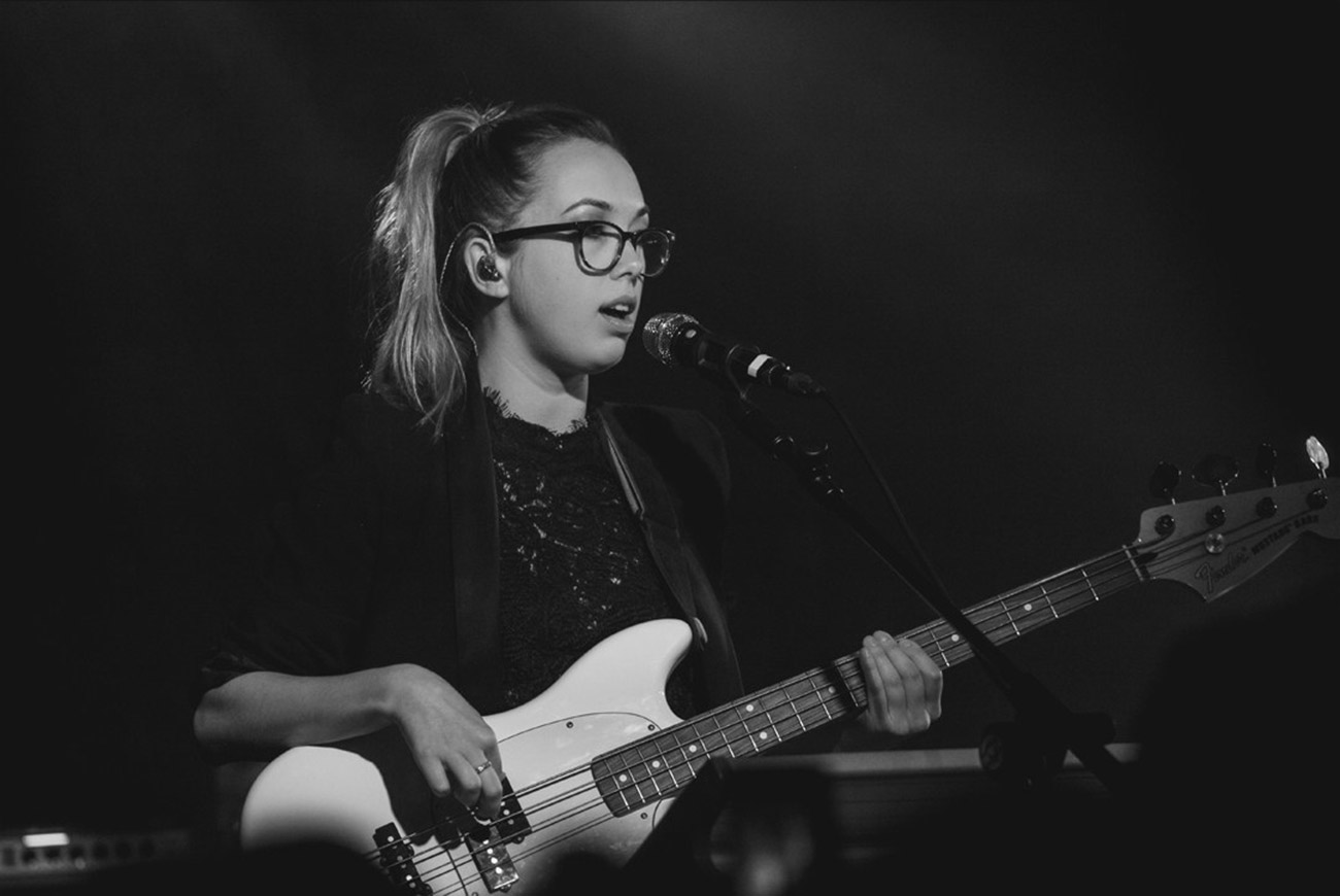 Hayley Jane Batt playing bass and singing on stage