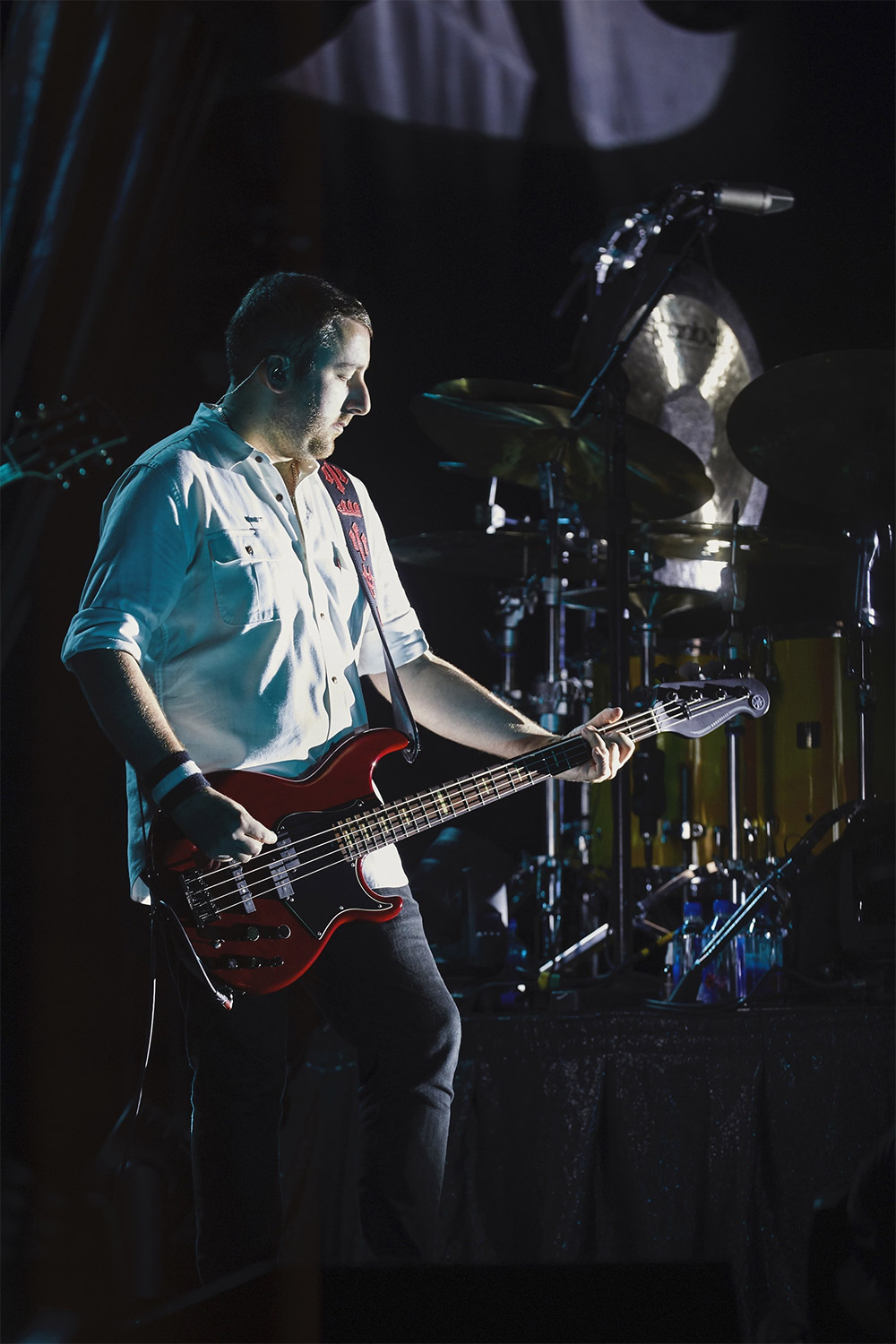 Jack Bates playing bass on a stage