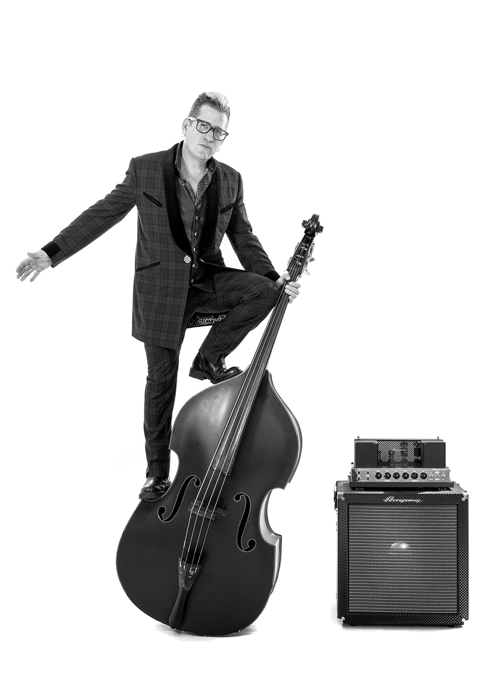 Lee Rocker standing on a double bass