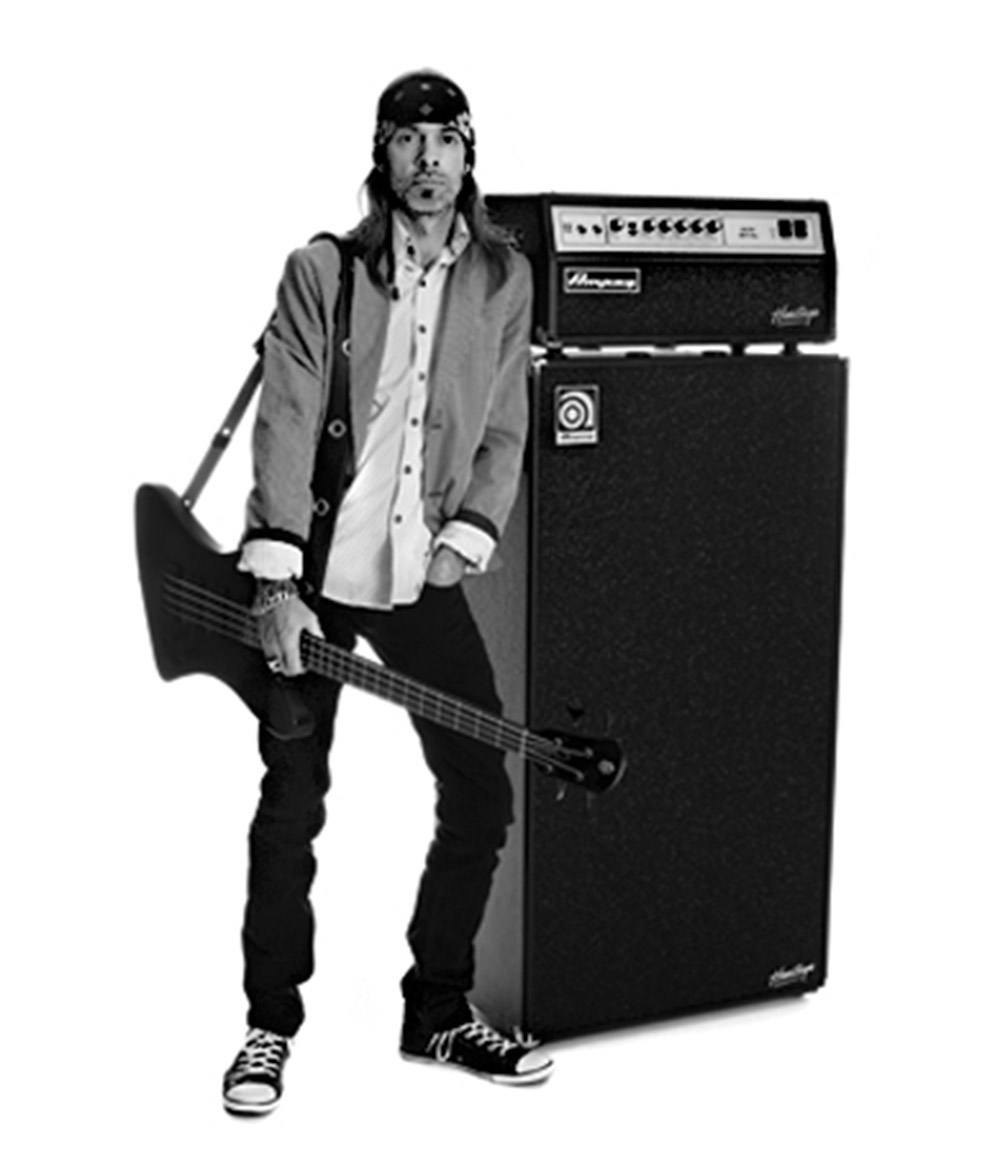 Rex Brown leaning against a Heritage SVT-CL and SVT-810E with bass in hand