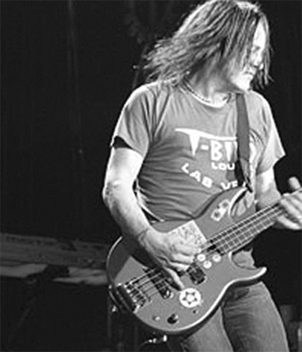 Robbie Takac playing bass on stage