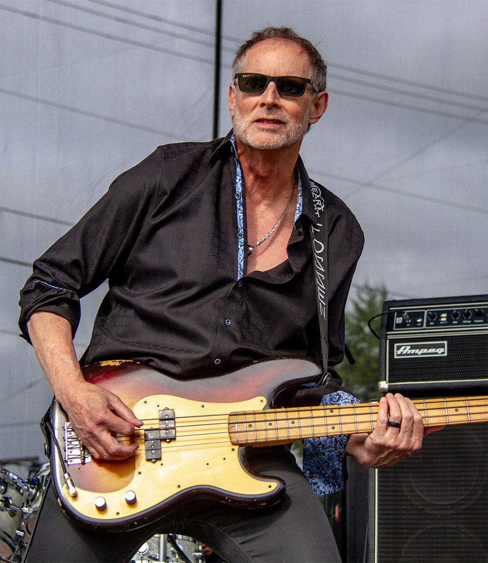 Steve Fossen playing bass on an outside stage