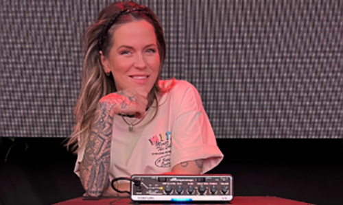 Moa Munoz standing behind her Ampeg head and cab