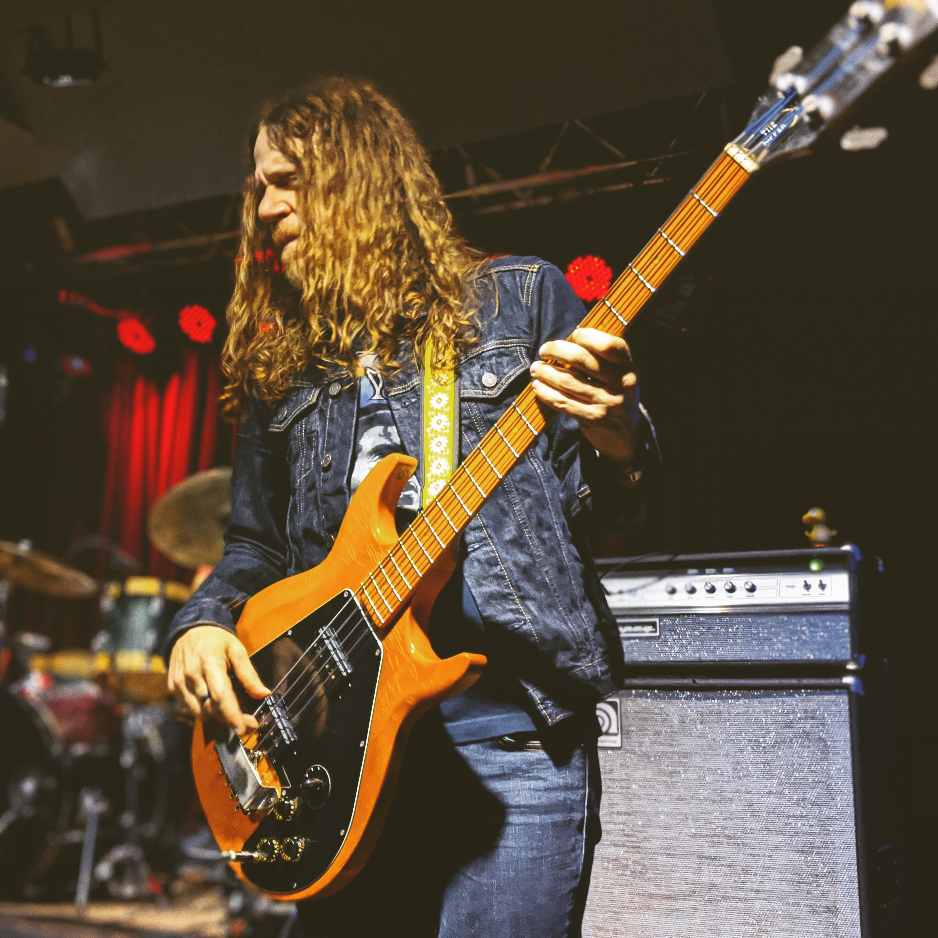 Tod Michel Bowers playing bass on stage in front of a V-4B