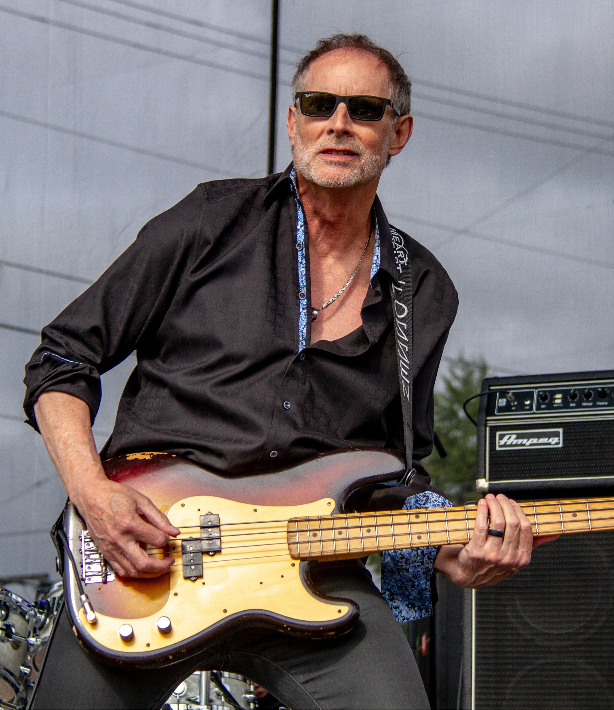 Steve Fossen playing bass on an outside stage