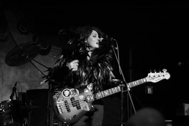 Abby Travis playing bass on stage