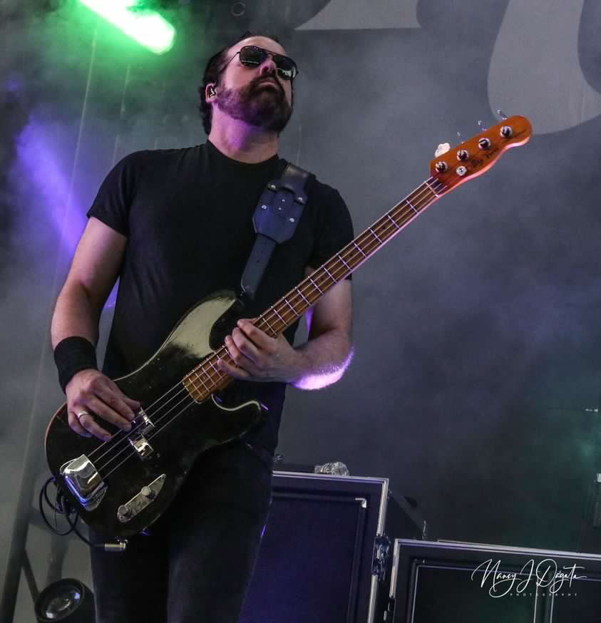 Mark Damon playing bass on stage
