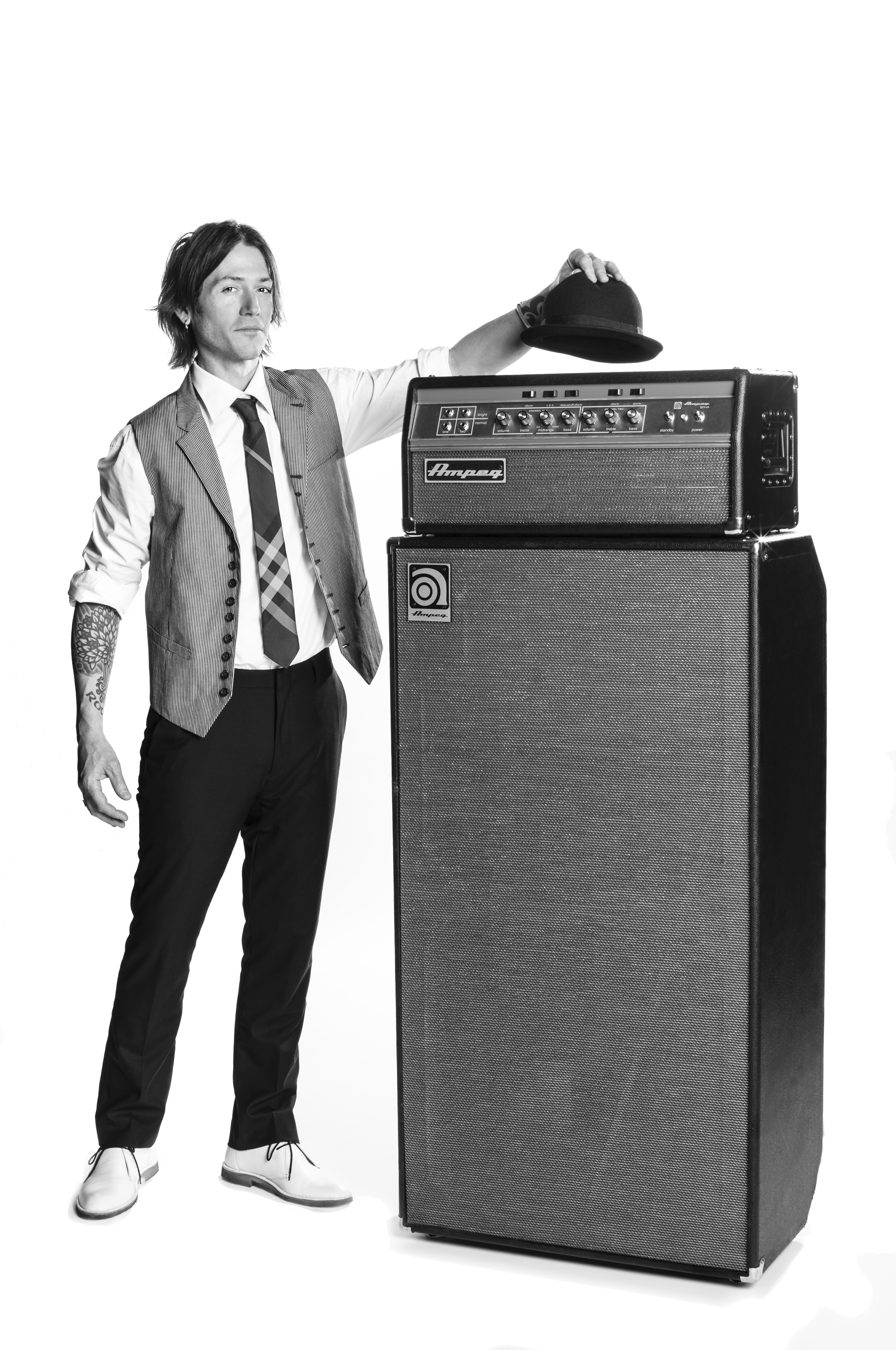 Robbie Harrington placing a derby hat on an Ampeg amp head