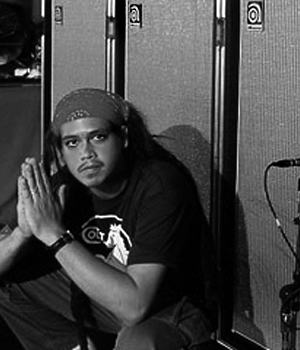 Chi Cheng sitting on a stage
