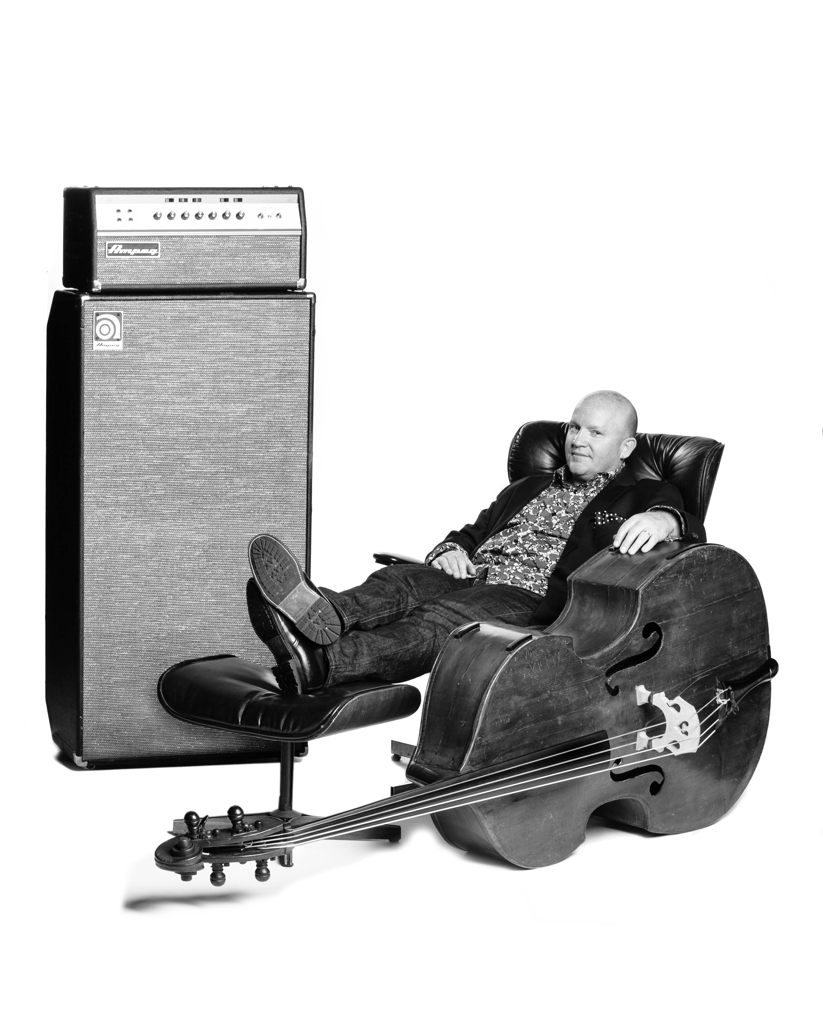 Dennis Crouch sitting on a chair with his hand on his double bass