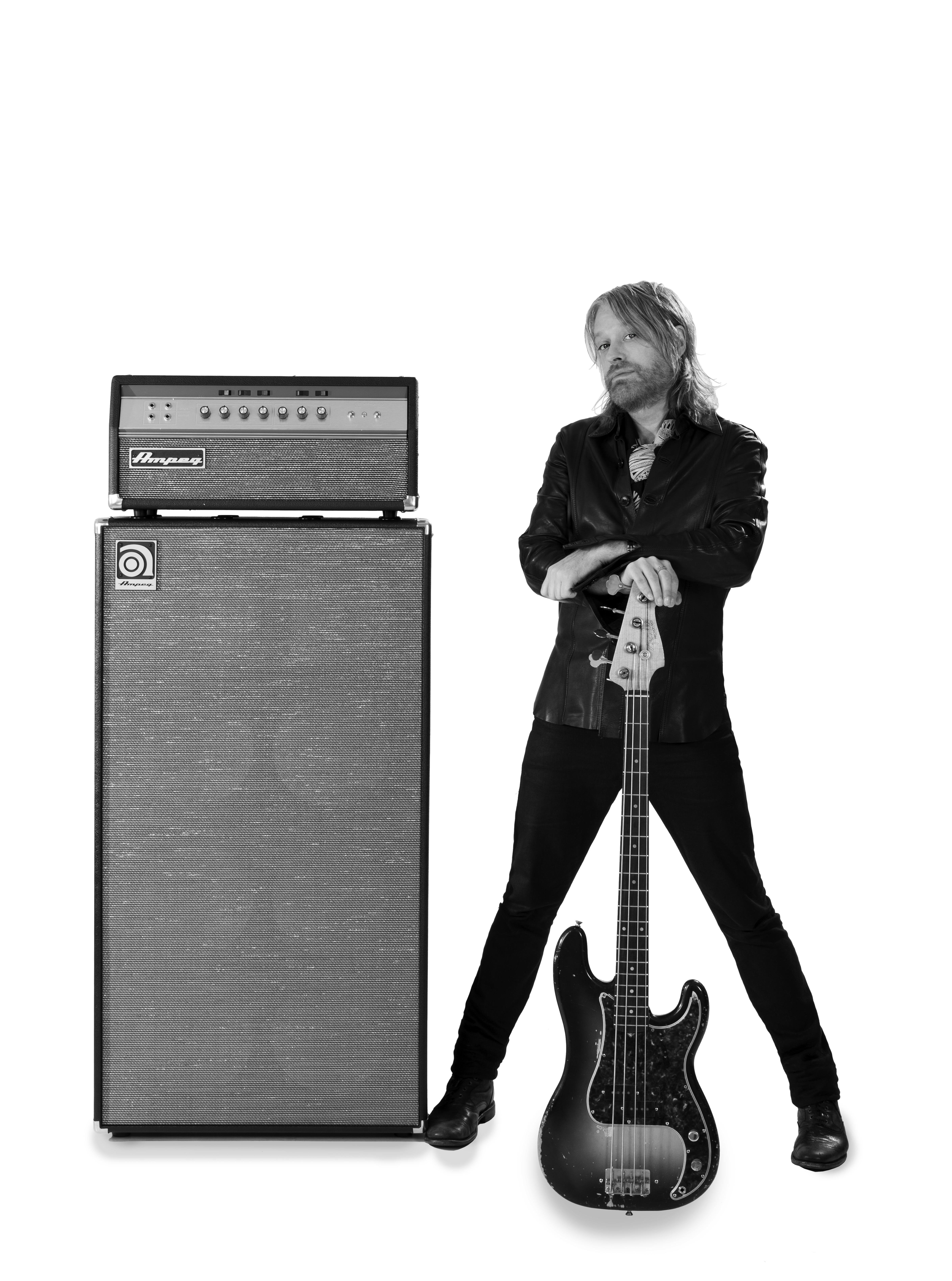 Chris Wyse standing by a SVT stack leaning on a bass