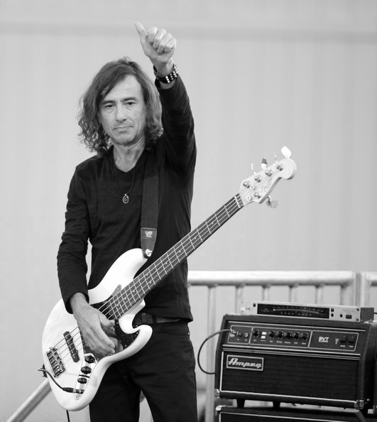 Juan Calleros holding his bass on stage