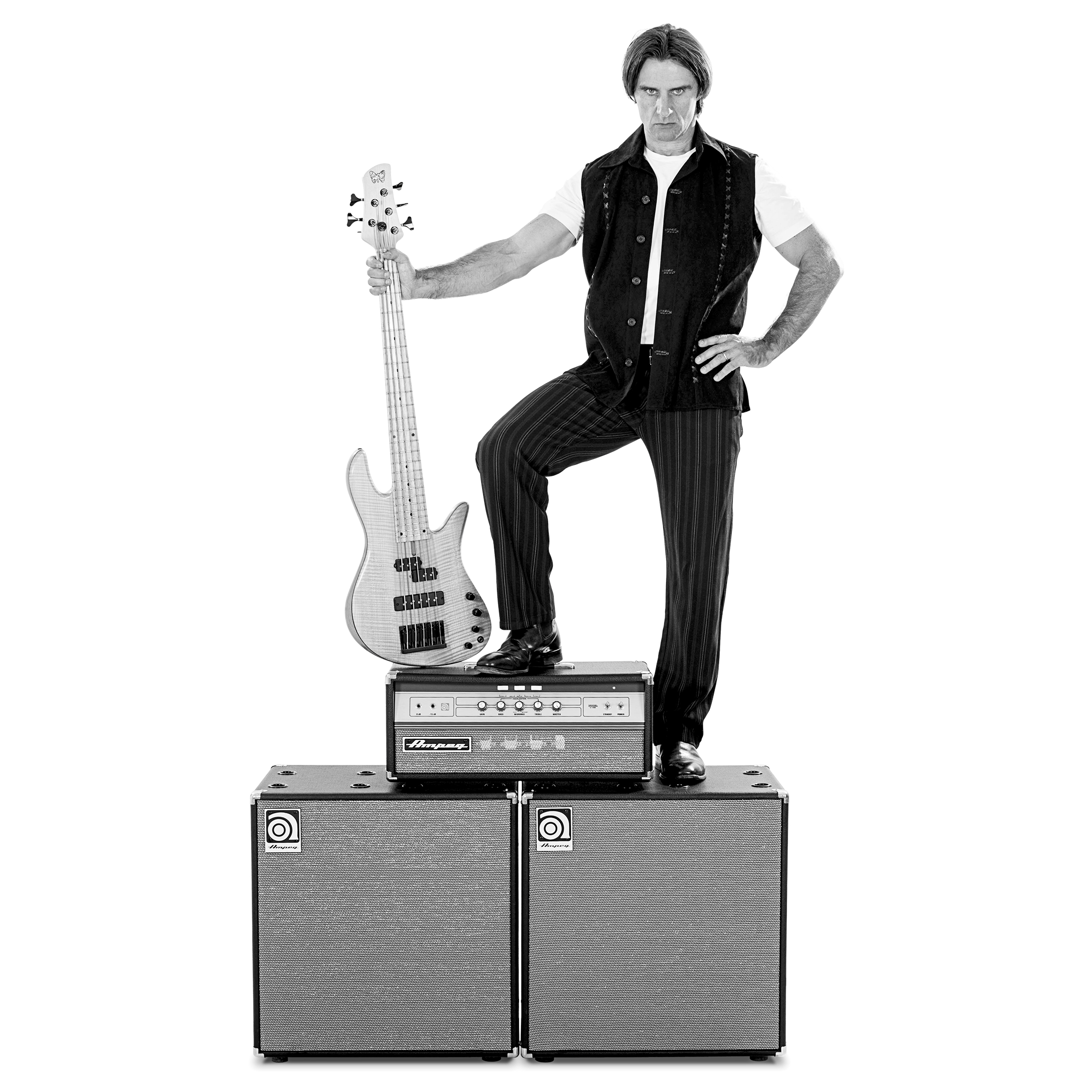 Andrew Cichon standing on Ampeg cabs and amp head holding a bass