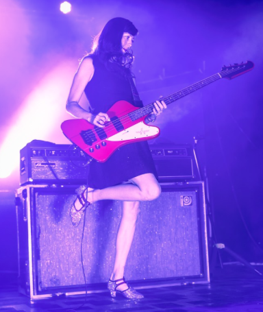 Nikki Monninger playing bass on stage