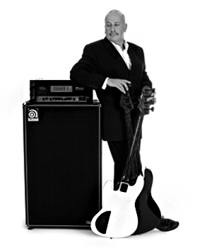 Hutch Hutchinson leaning on a SVT stack with two basses in front of him