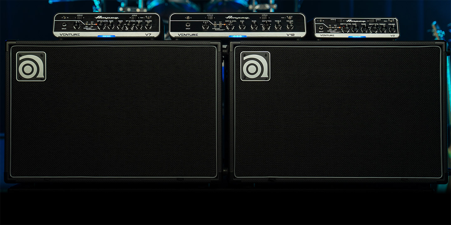 Venture V3, V7, and V12 bass amps sitting on top of two VB-112 cabs on stage.