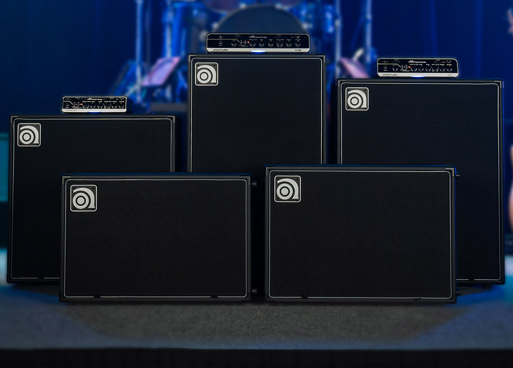 Venture V3, V7, and V12 bass amps with VB-112, VB-115, VB-210, VB-212, and VB-410 cabs on stage.