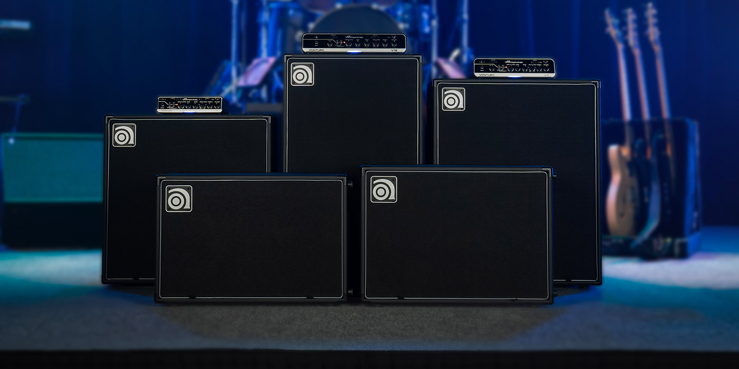 Venture V3, V7, and V12 bass amps with VB-112, VB-115, VB-210, VB-212, and VB-410 cabs on stage.